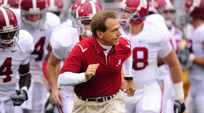 Alabama Crimson Tide football coach Nick Saban runs on the sideline during a game.